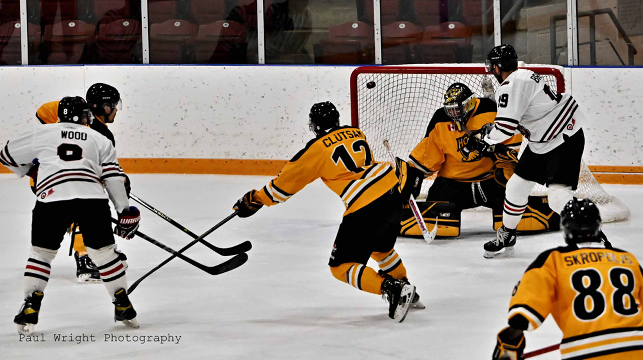 The McCoys' Phil Brewer scoring on the Cambridge Hornets net.