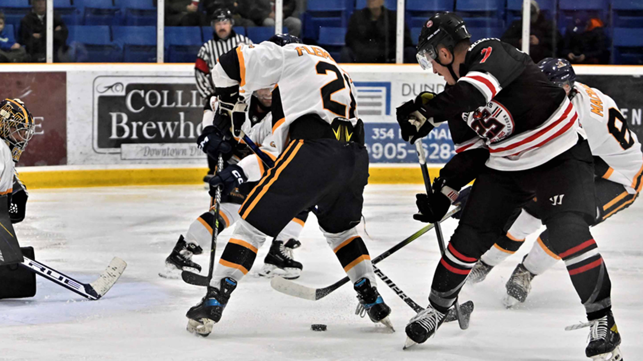 Dundas' Sheeran battling for the puck in front of the Gryphins net