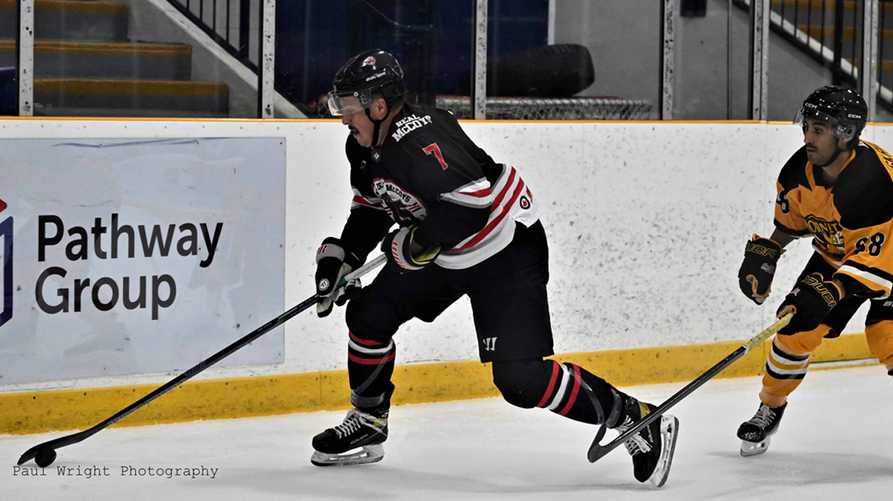 Nolan Sheeran (Dundas) being chased by Yianni Skropolis (Cambridge)