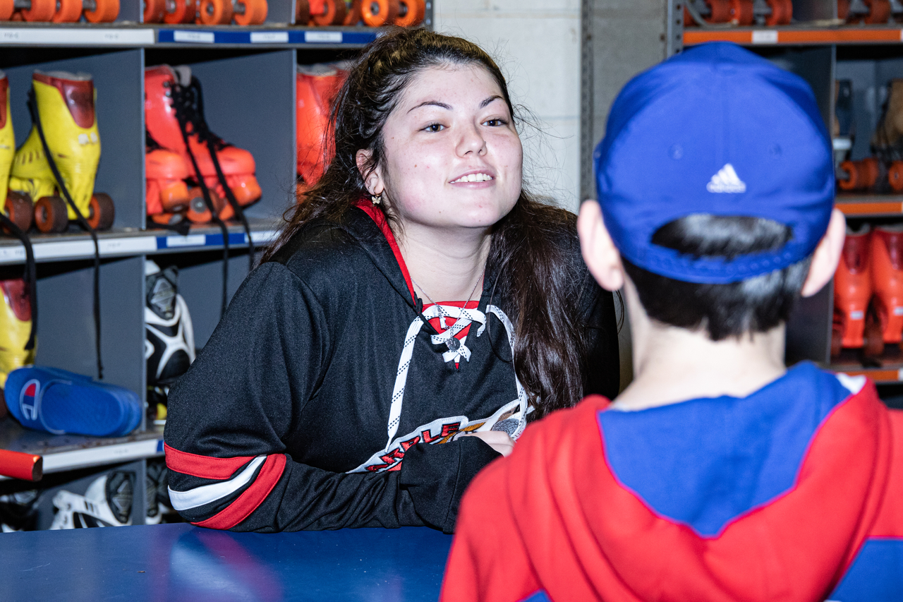 Skate Rental attendant smiles at a young skater at Marple Sports