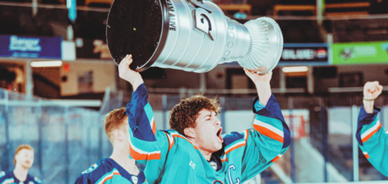 LUG hockey captain lifting a championship trophy
