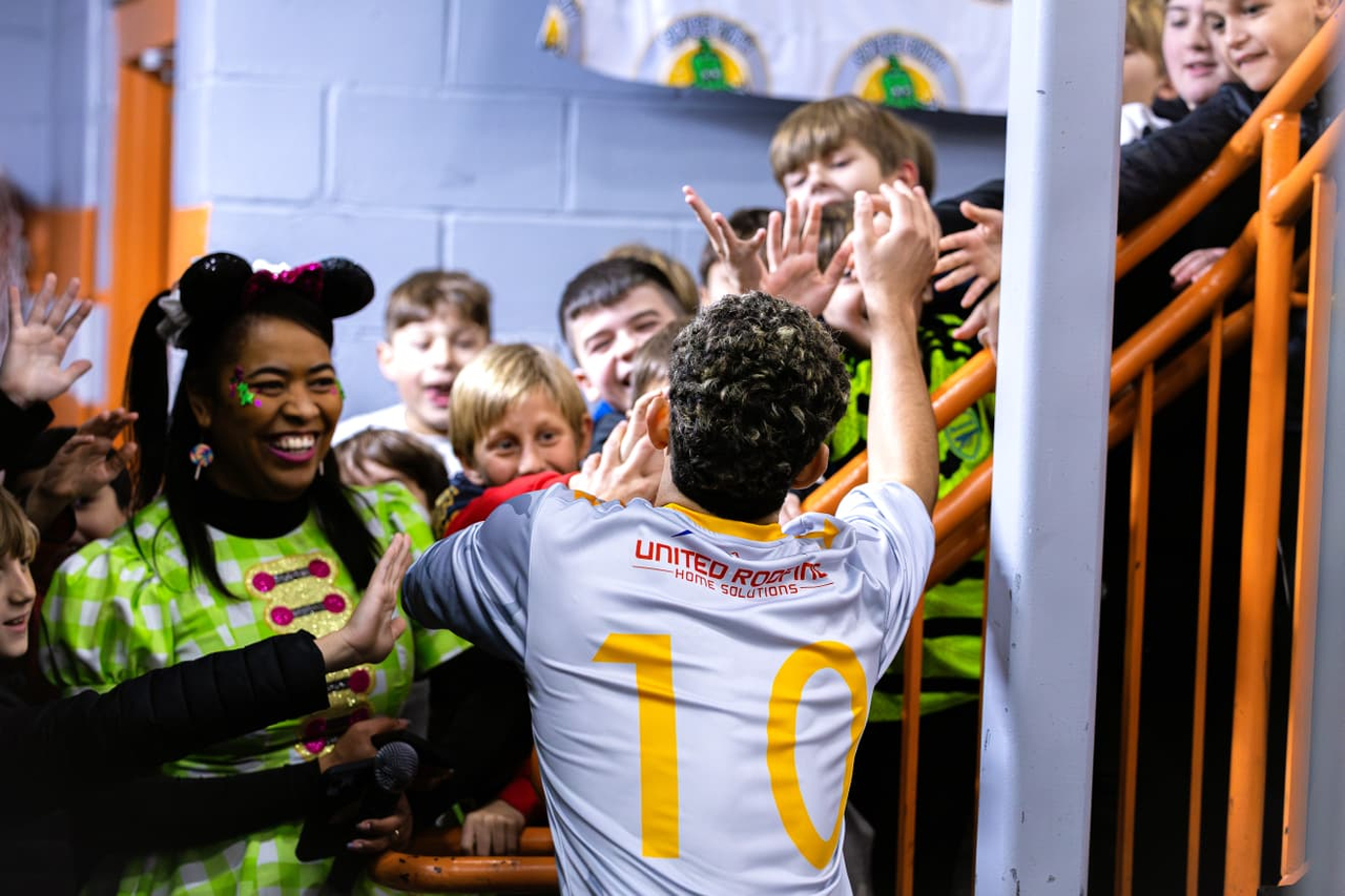 Spice City player celebrating with children