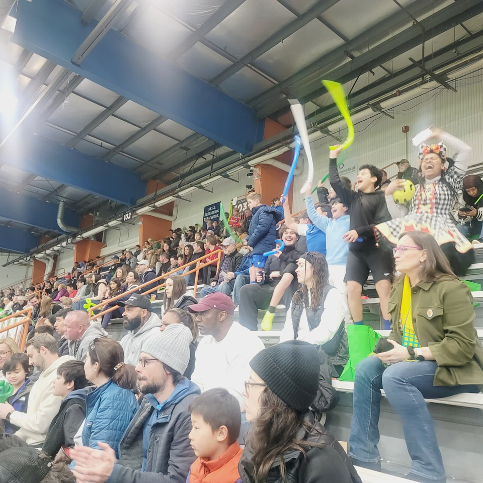 Children in the stands joyfully cheering on their team, Spice City FC