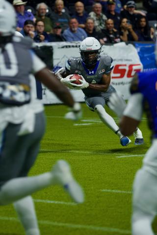 Bombers runner breaks free, sprinting downfield as defenders chase from behind.