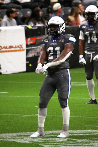 #21 locked in under the lights, ready as the action blurs behind him.