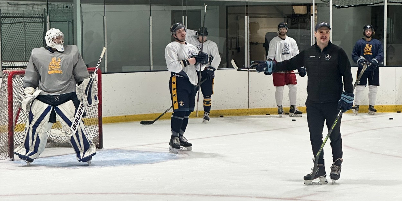 Coach Thompson coaching players through drills.