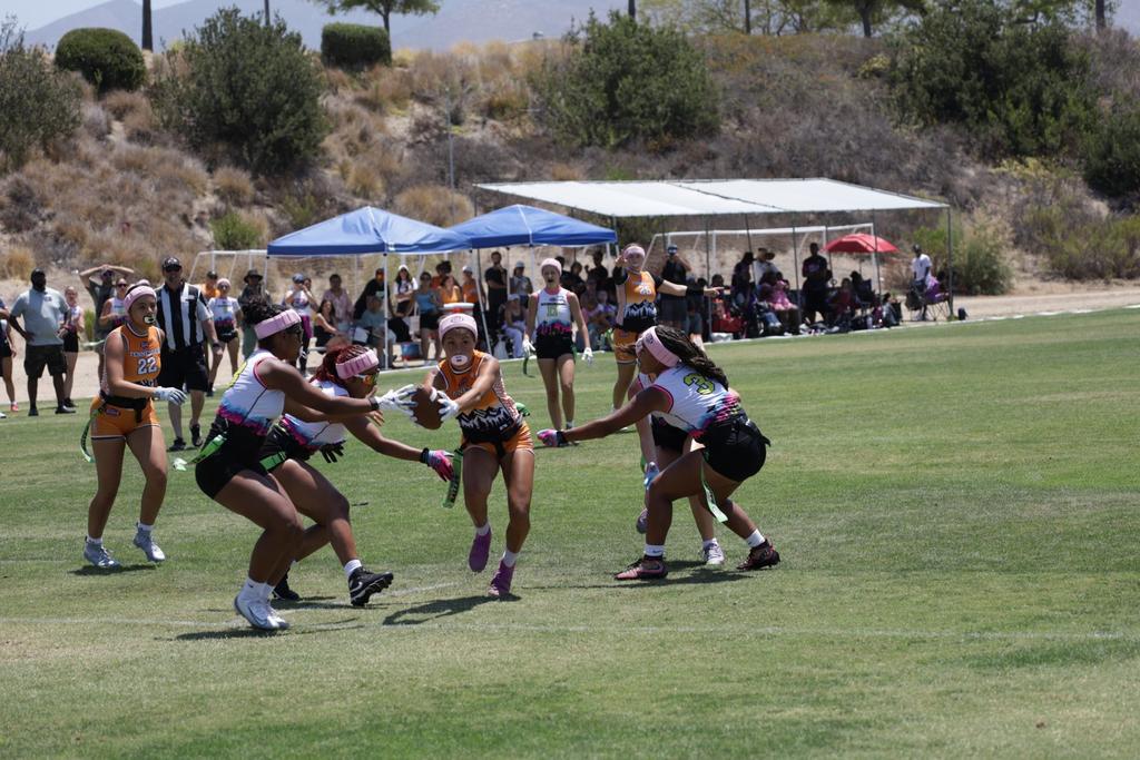 Girls flag football athletes competing in open space
