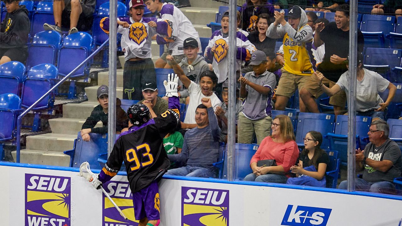 Haudenosaunee fans celebrate with player after a goal
