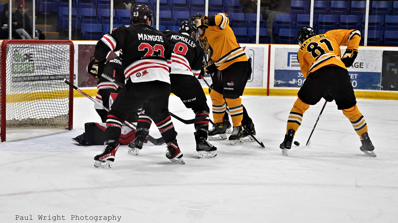 Cambridge's Steve MacAulay backhanding a shot at the Dundas net