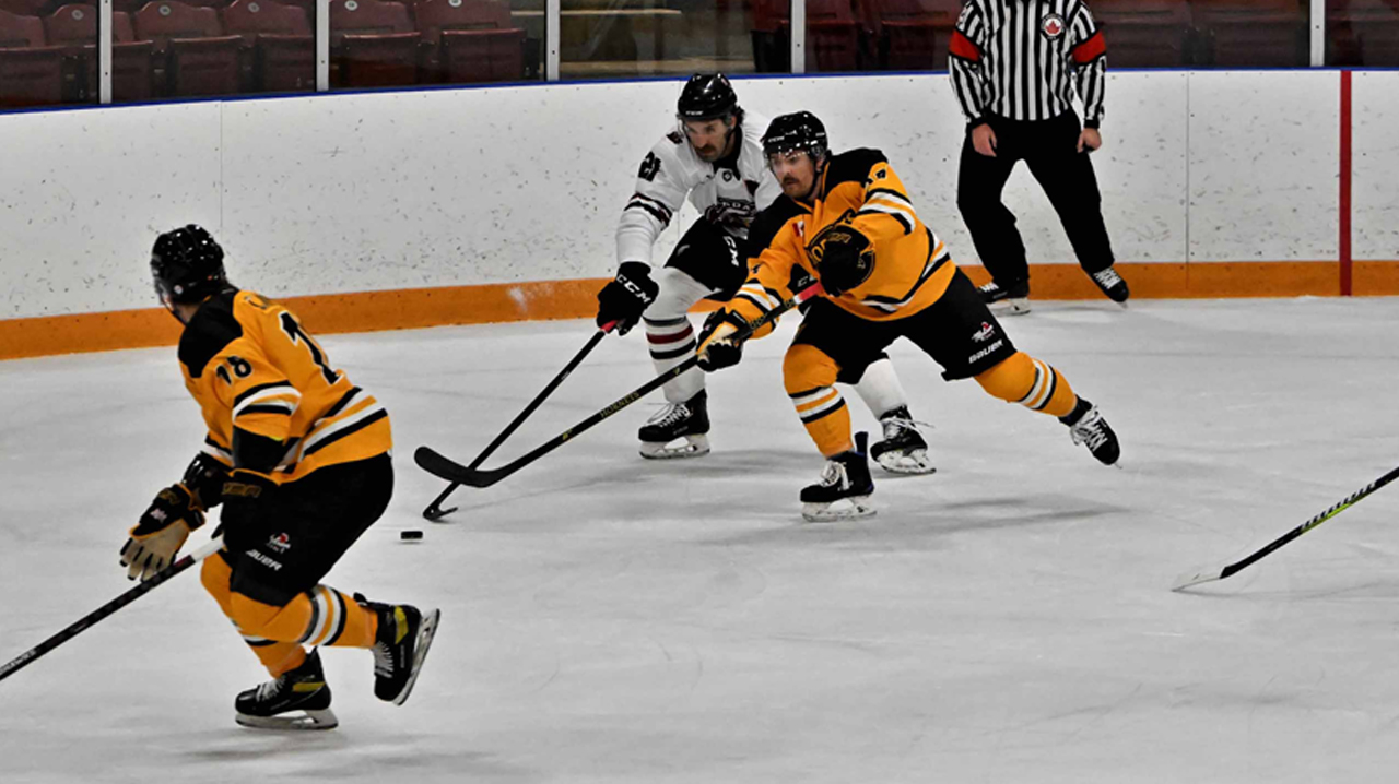 Wilson (Cambridge) advancing the puck with DaSilva (Dundas) trying to strip the puck.