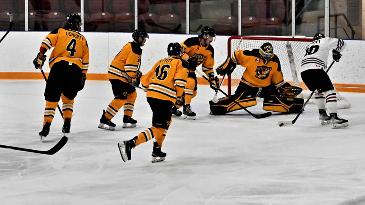 Holden Doggett (Dundas) trying to score on the Cambridge Hornets net