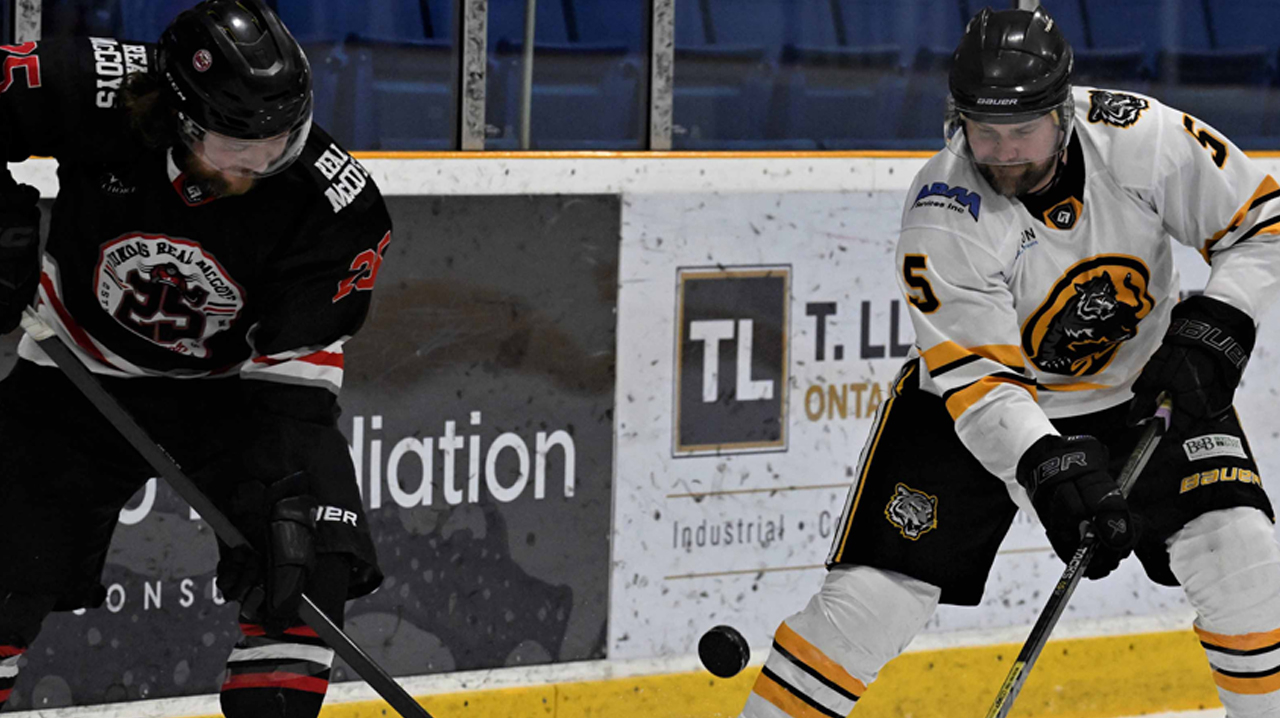 Hackett (Dundas) and Matt Ruberton (Stoney Creek) battle for a puck