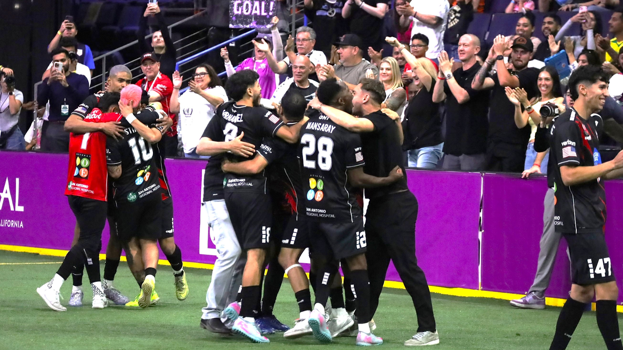 Photo of Strykers players celebrating the game winner in front of fans