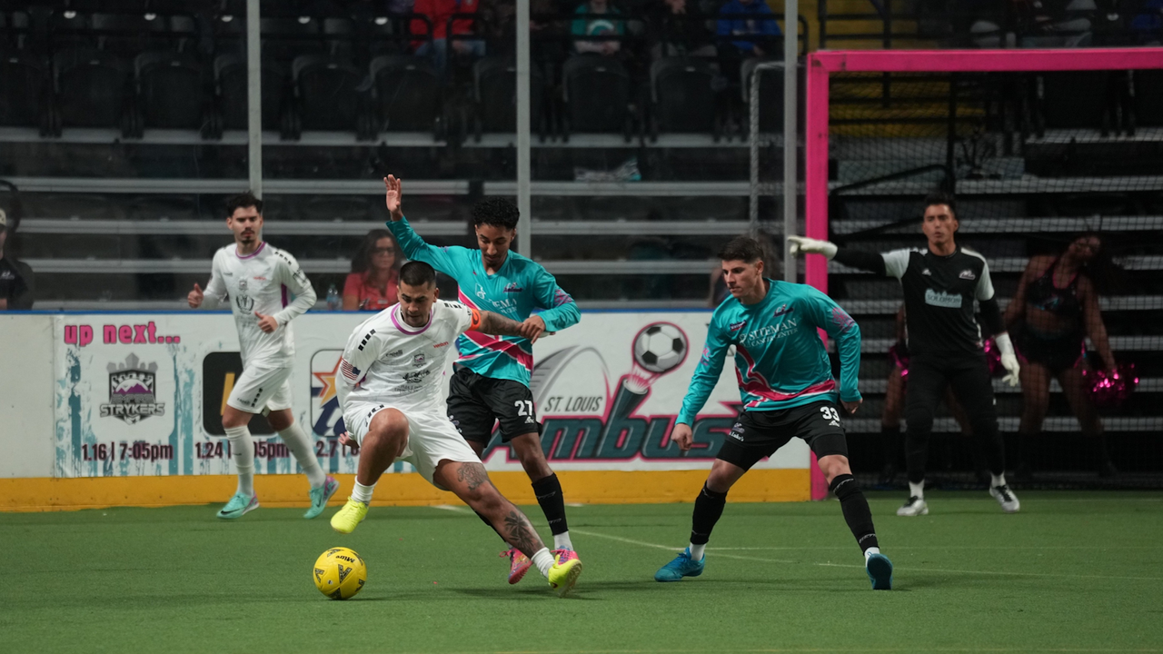 Photo of Justin Stinson shielding the ball at St. Louis