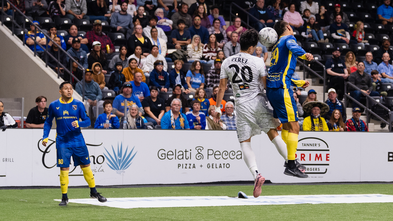 Alan Perez battling for a header at San Diego