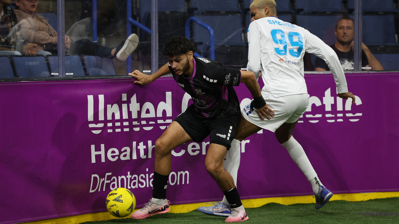 Photo of Polo Hernandez shielding the ball from Barbaro Shelier (then with Utica)