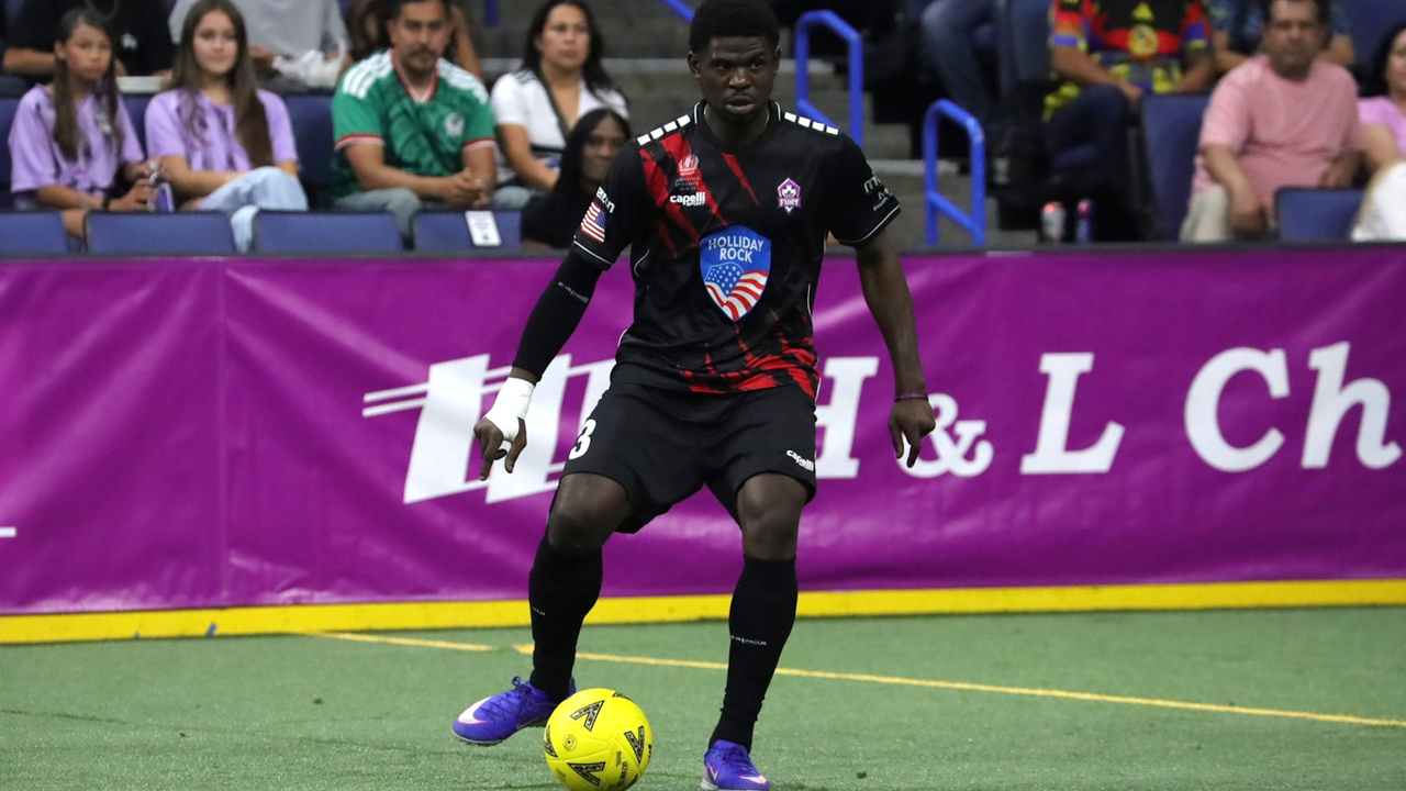 Photo of Qudus Lawal passing the ball in a game at Toyota Arena