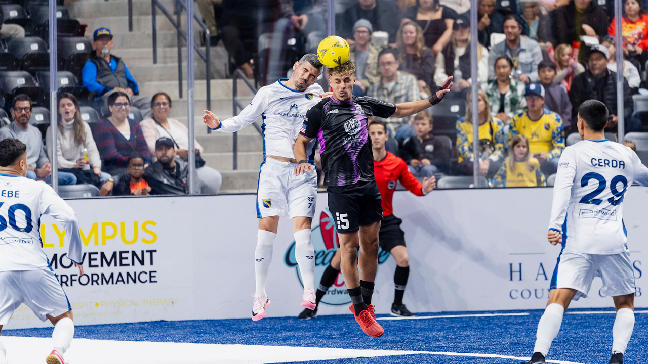 Photo of Felipe Gonzalez (San Diego) & Mounir Alami (Empire) in a header duel