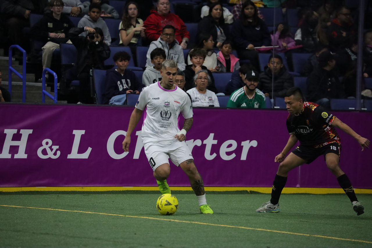 Justin Stinson with ball against defender.