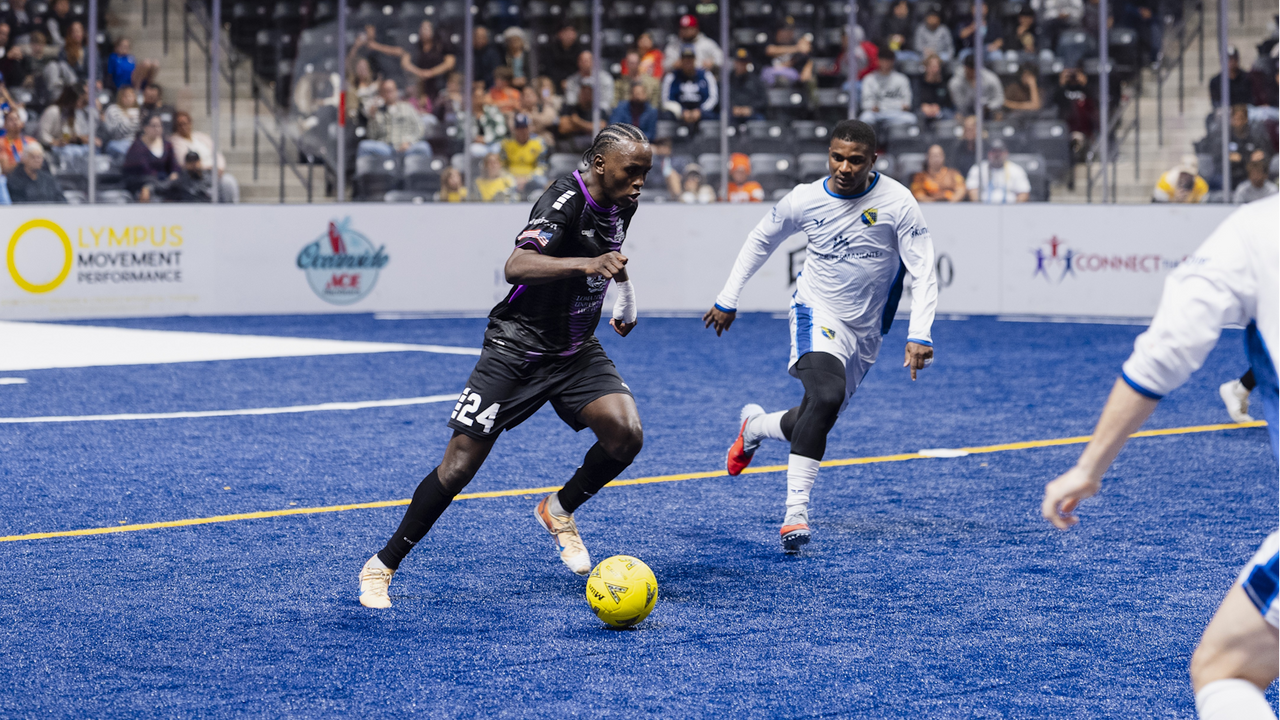 Photo of Issak Somow running with the ball against San Diego