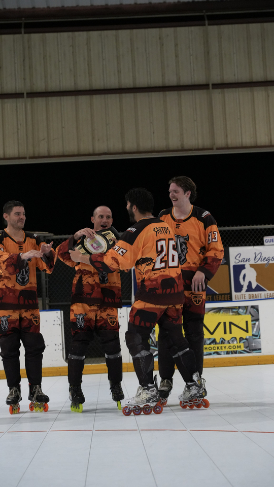 The Rhinos cheer as team co-captain Noe Santos is recognized as series MVP.