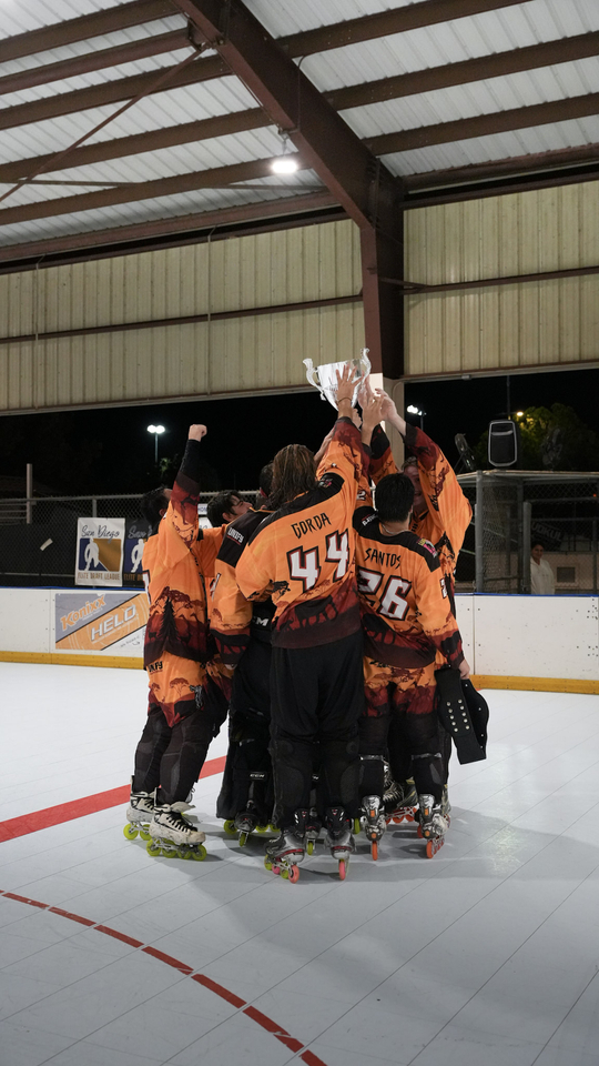 The Rhinos celebrate at center ice with the McClurg Championship Cup.