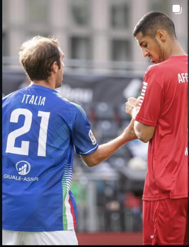Italy and Afghanistan players greet each other