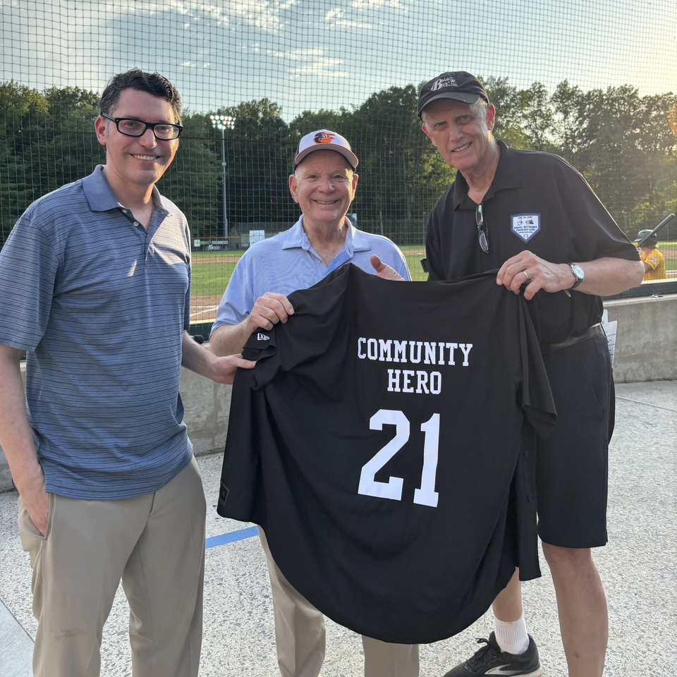 Bruce Adams presenting Senator Ben Cordin and Marc Korman with a Big Train Community Hero jersey