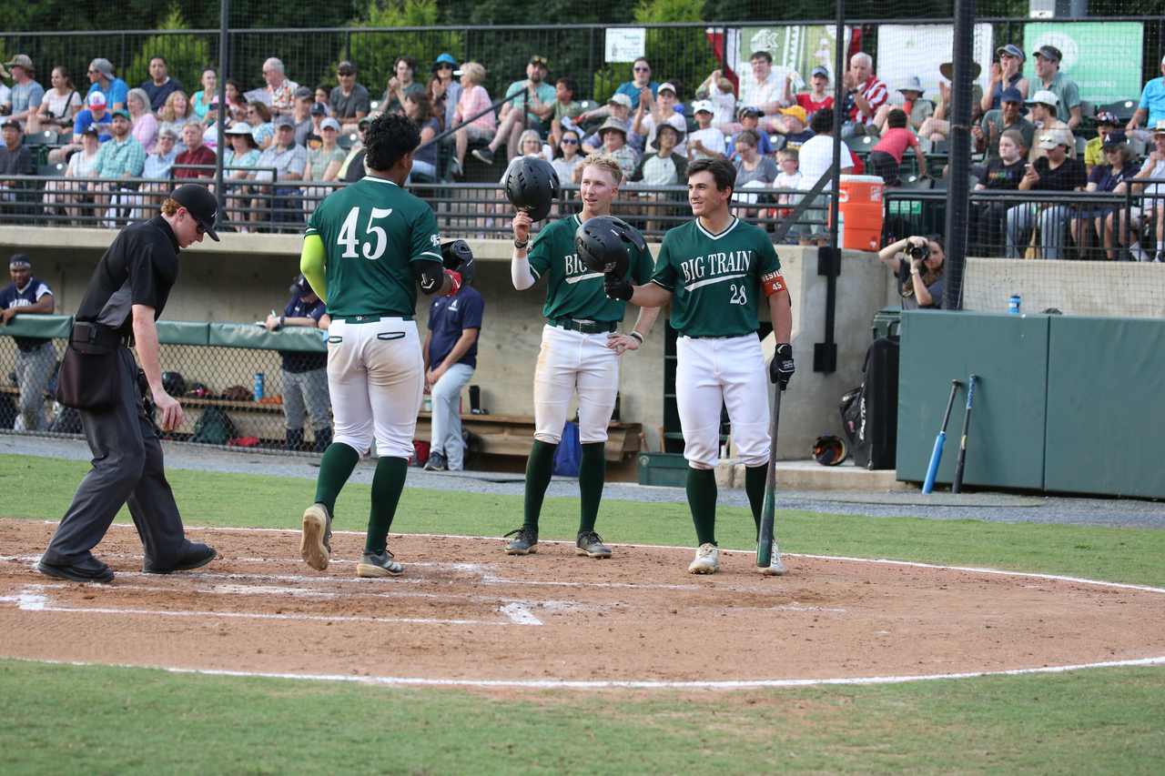 Emilio Gonzalez celebrating HR with Brennon Wright and Matt Westley by Mark Thalman